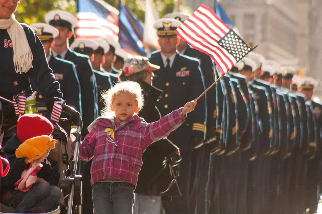 Thank you for your service! Image of U.S. Coast Guard families and service members in New York City Veterans Day Parade, also used for Memorial Day 2024 blog post